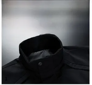 Detail of a high-quality stand collar men jacket with a sleek black snap button closure
