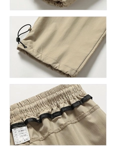 Détail du pantalon cargo kaki montrant l'ourlet à cordon et la taille élastique avec étiquette