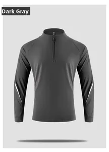 Close-up of dark grey sports sweatshirt featuring a half-zip collar and reflective arm stripes