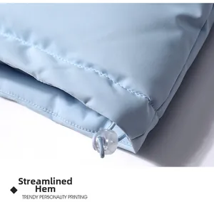 Close-up of the light blue windproof jacket fitted hem with adjustable elastic drawstring