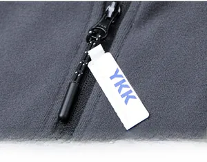 Detailed macro view of the original black YKK zipper on a grey fleece sports sweatshirt