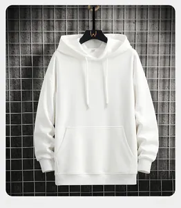 Detail view of white hoodie sleeve cuffs and kangaroo pocket on metal grid background