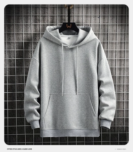Detail of grey hoodie showing cotton blend fabric texture and front kangaroo pocket