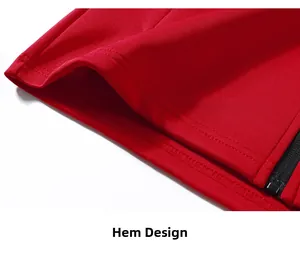 Detail view of red athletic jacket hem with high-quality stitching and black zipper closure