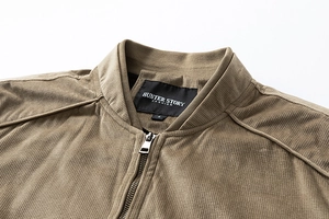 Detailed close-up of khaki faux suede jacket collar with bronze metal zipper and texture