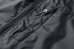 Macro shot of black ripstop fabric with durable grid texture and metal zipper detail
