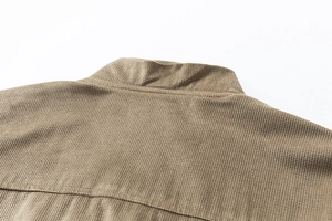 Close-up of khaki suede jacket collar showing waffle texture fabric and seam stitching