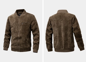 Detailed view of dark brown corduroy jacket with zipper pockets and ribbed hem