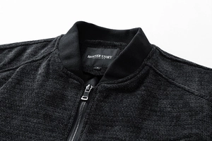 Close-up of textured heavy cotton fabric with zipper and brand label on jacket