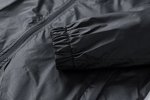 Macro view of elastic cuff and ripstop fabric texture on this black hooded windbreaker