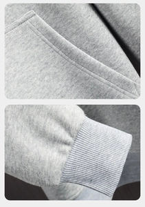 Close-up of grey hoodie detailing double-stitched pocket edges and ribbed knit cuffs