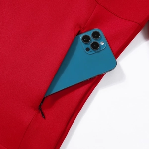 Red men's athletic jacket with hidden zipper pocket holding a blue smartphone for storage