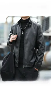Detail of black faux leather jacket with stand collar and metallic zipper texture
