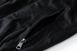 Detailed macro view of high-quality black suede jacket fabric with a metal zipper pocket