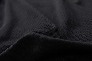 Close-up detail of breathable black honeycomb mesh fabric for premium jackets