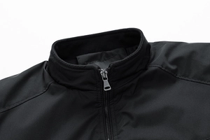Detail view of high-quality black stand-up collar with metallic zipper and neat stitching