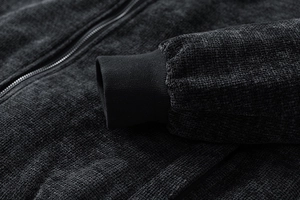 Detail of ribbed knit cuffs and heavy cotton-linen textured fabric on a retro jacket