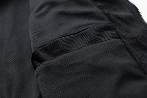 Detail shot of black jacket interior featuring breathable mesh fabric and reinforced seams