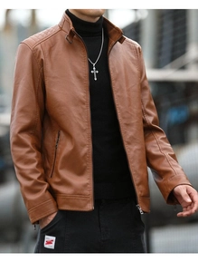 Close-up of brown leather biker jacket featuring stand collar and quilted shoulder details