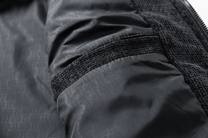 Detailed macro view showing the textured diamond lining and black zipper of the men jacket