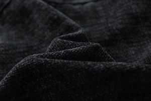 Macro shot of black corduroy fabric texture and ribbed material for men's retro jacket