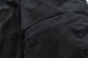 Close-up of the premium black thermal fleece lining and inner stitching of the jacket
