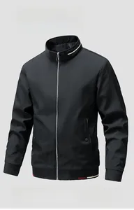 Detail of black stand collar jacket featuring red and white striped ribbing and metal zipper