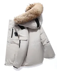 Detail view of the plush brown faux fur collar on a creamy white parka with fashion patch