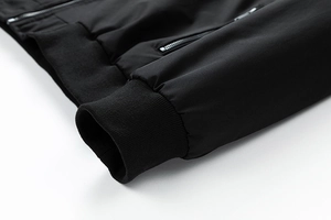 Detail view of black flight jacket featuring elastic ribbed cuffs and a premium metal zipper
