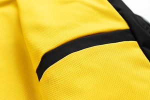 Detailed macro view of yellow hexagonal honeycomb mesh fabric with breathable texture