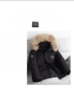 Close-up of premium black parka jacket featuring a fluffy light brown faux fur collar