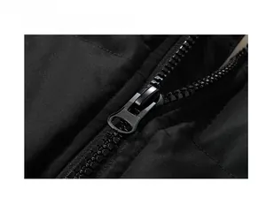 Macro detail of high-quality black jacket featuring a durable matte metal zipper closure