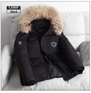 Detail of black parka jacket featuring thick faux fur collar and fashion utility pockets