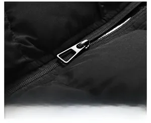 Close-up of high-quality smooth metal zipper on black quilted puffer vest for men