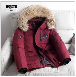 Detail of burgundy parka with thick faux fur hood and windproof ribbed cuffs for winter