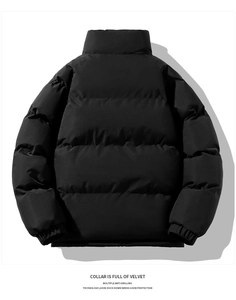 Detail view of black puffer jacket showing anti-drilling fabric and velvet-lined collar