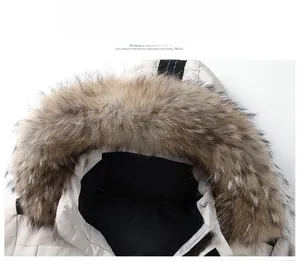 Detail of detachable faux fur collar and textured hood on beige winter parka jacket