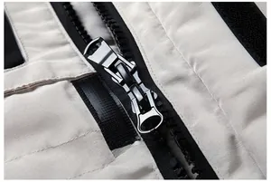 Detail shot of heavy-duty double metal zipper on off-white parka outdoor jacket
