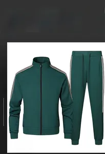 Detailed close-up of dark green tracksuit with white side stripes and ribbed cuffs