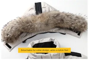 Detail of a beige winter parka featuring a detachable fluffy fur collar and a hood