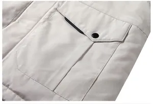 Detail of cargo pocket with black metal snap button on beige parka jacket