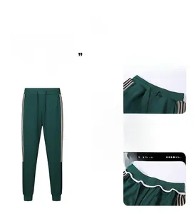 Detail of dark green men's track pants with white side stripes and drawstring waist