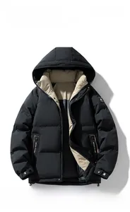 Detail view of black winter hooded parka featuring khaki lining and decorative logo strap