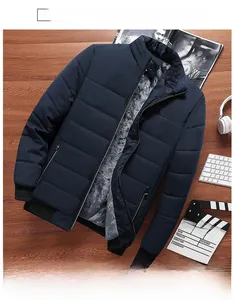 Detail view of navy blue men's winter jacket with warm thick fleece lining on wood background