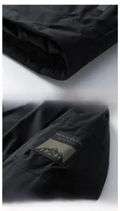 Detail view of smooth garment hem and printed sleeve pocket on graphene winter jacket