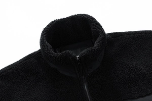Detail of high collar zipper and warm black sherpa fleece fabric texture for men jacket