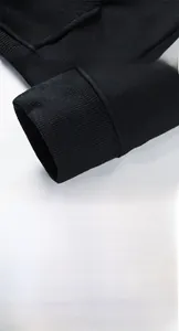 Detail of high-elasticity ribbed cuffs and precision four-thread stitching on cotton hoodie