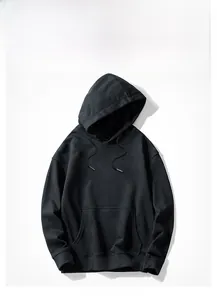Detailed close-up of a black cotton hoodie featuring kangaroo pocket and ribbed cuffs