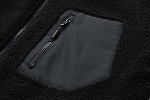 Detail of sherpa fleece jacket featuring a zippered chest pocket and woven fabric patch