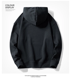 Detailed studio shot of black cotton hoodie with ribbed cuffs and drop shoulder design